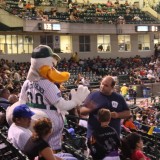 Long Island Ducks mascot QuackerJack high-fives a fan. (July 24, 2012) Photo by Glenda Sanchez