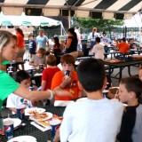 Sarah Schreiner of the Greene Team interviews young Long Island Ducks fans as they enjoy refreshments during the game on July 24. 2012 at Bethpage Ballpark. Photo by Matthew Maron