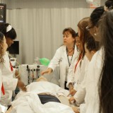 HCOP students are given hands-on experience using a dummy on July 25, 2012. Photo by Matthew Maron